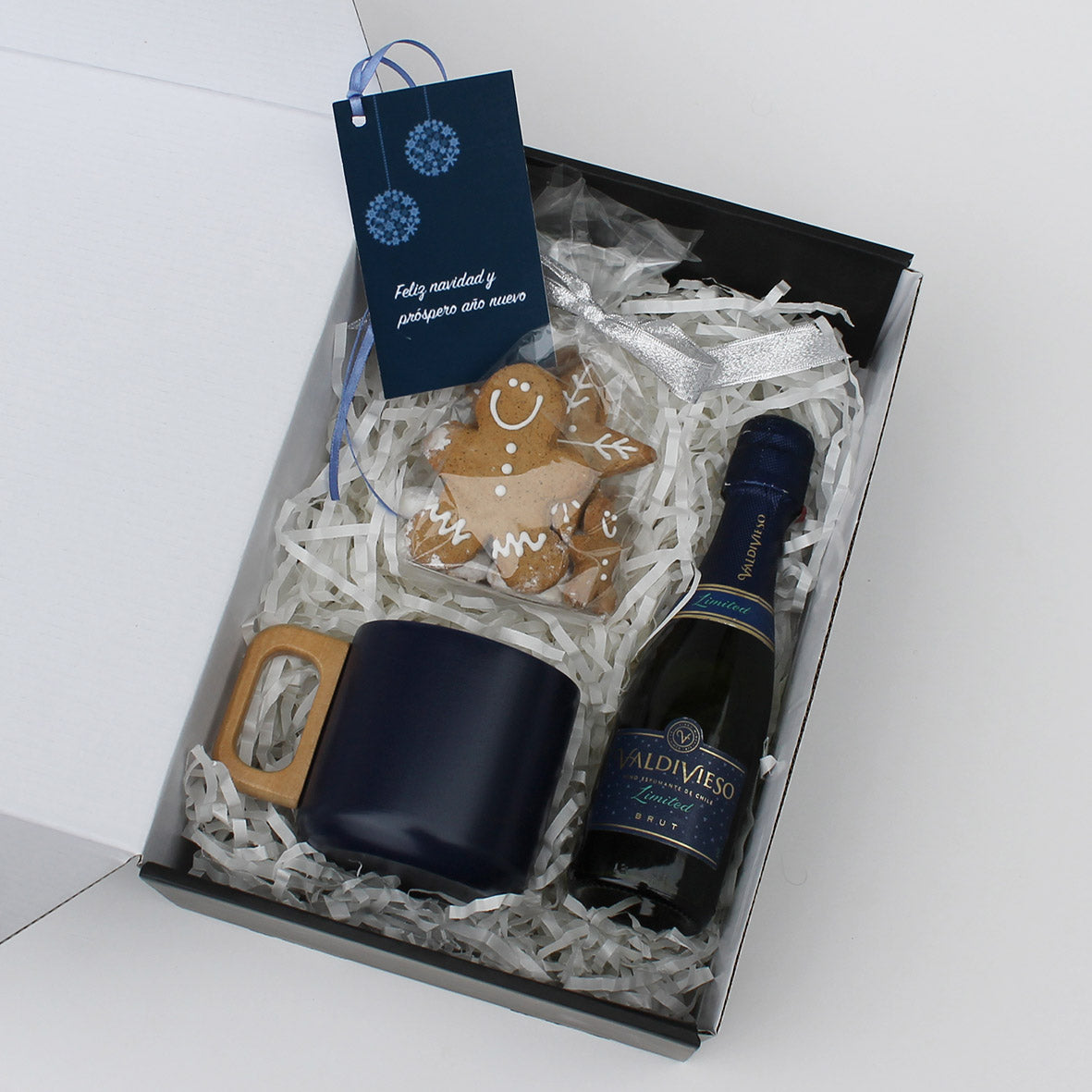“Regalo Azul Burbujeante con espumante Valdivieso, taza doble pared y galletas navideñas – Aporta Imagen Chile”
