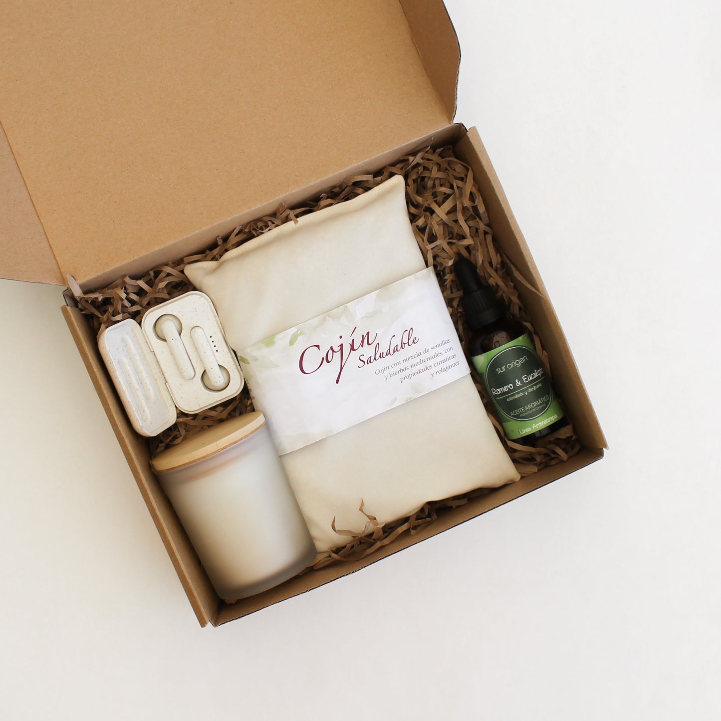 Cojín de semillas, aceite corporal natural, audífonos bluetooth eco y vela aromática de vainilla. En caja kraft personalizada con logo empresa.