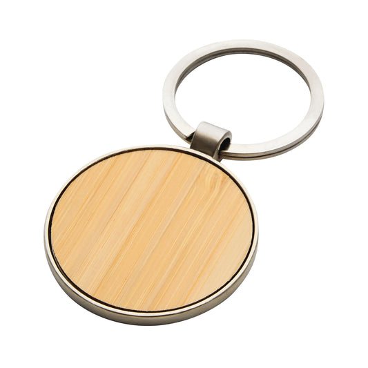 Llavero circular resistente de aleación de zinc con acabado brillante. Panel de bambú ideal para grabado o impresión de logo. Calidad premium para regalar.
