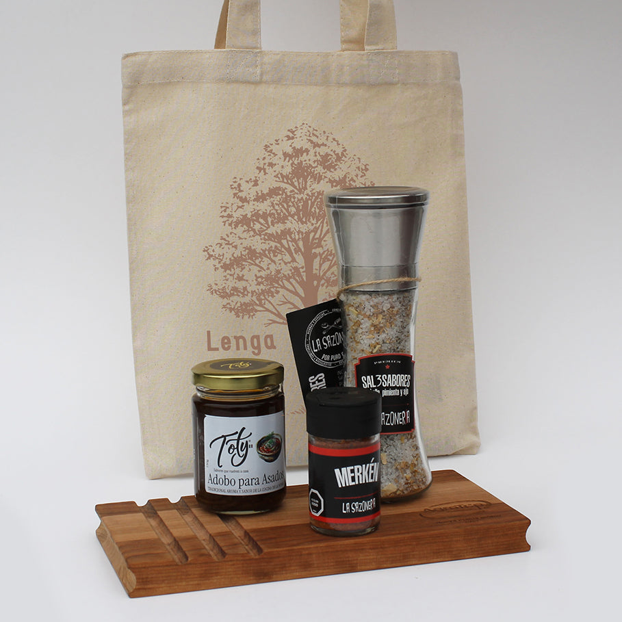 Set gourmet para asado con tabla de lenga, sal especiada, merkén y adobo. Presentado en bolsa de algodón personalizada con logo corporativo.