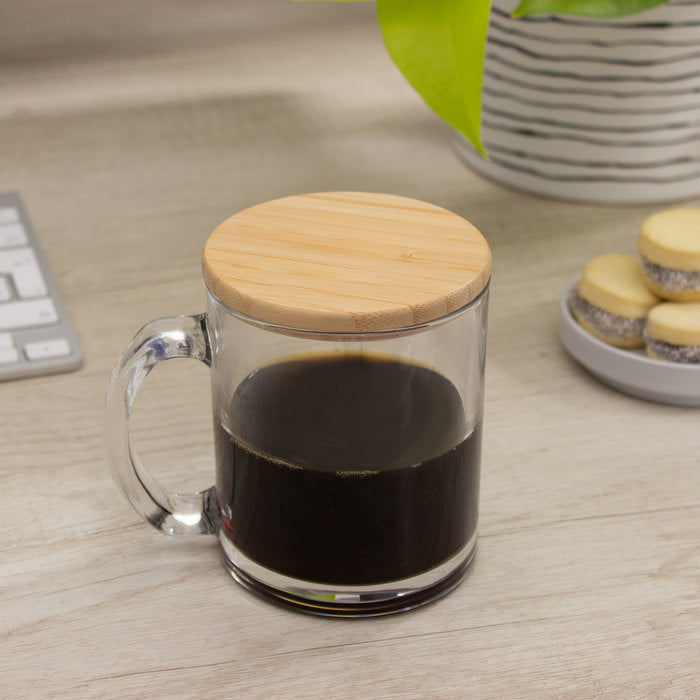 Taza de vidrio 350ml con tapa de bambú barnizado. Ideal para merchandising corporativo con logo impreso o grabado. Mínimo 100 unidades.